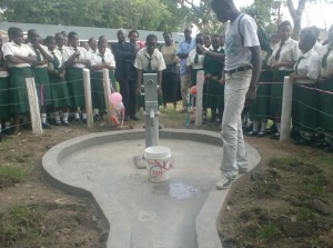 BWP officer giving instructions on operation of handpump scheme during handover ceremony