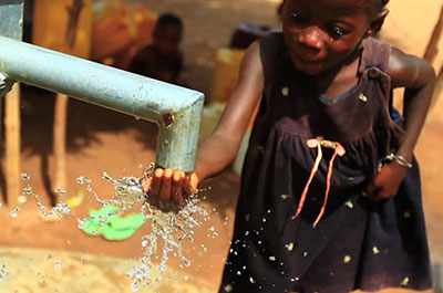 Girl at new well in Sierra Leone