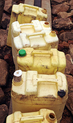 Jerry cans at a well