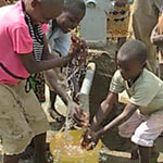 Boys in Kenya playing at new water well