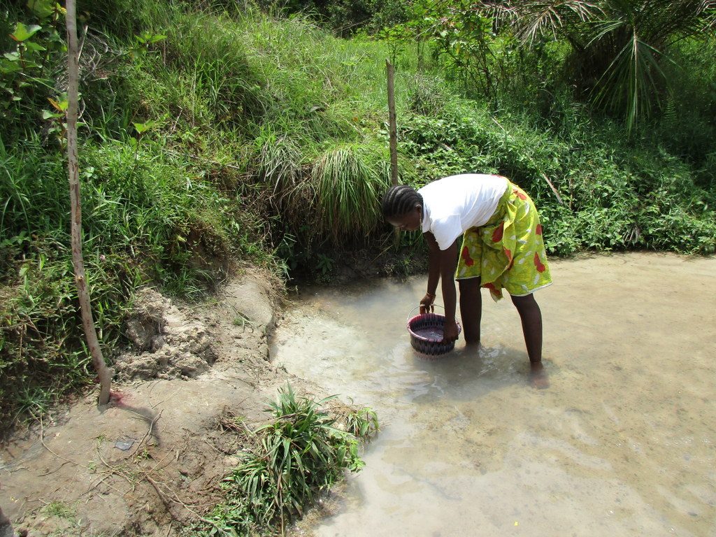The Water Project : sierraleone18270-filling-bucket-with-water-from-open-source