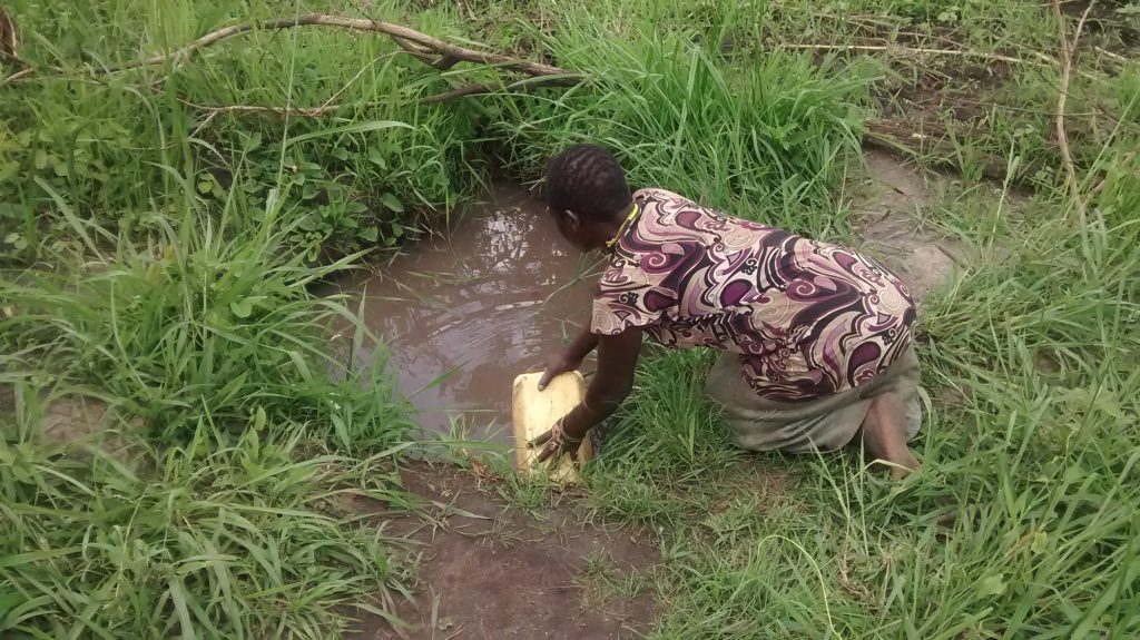 The Water Project : uganda18300-filling-jerrican-with-water