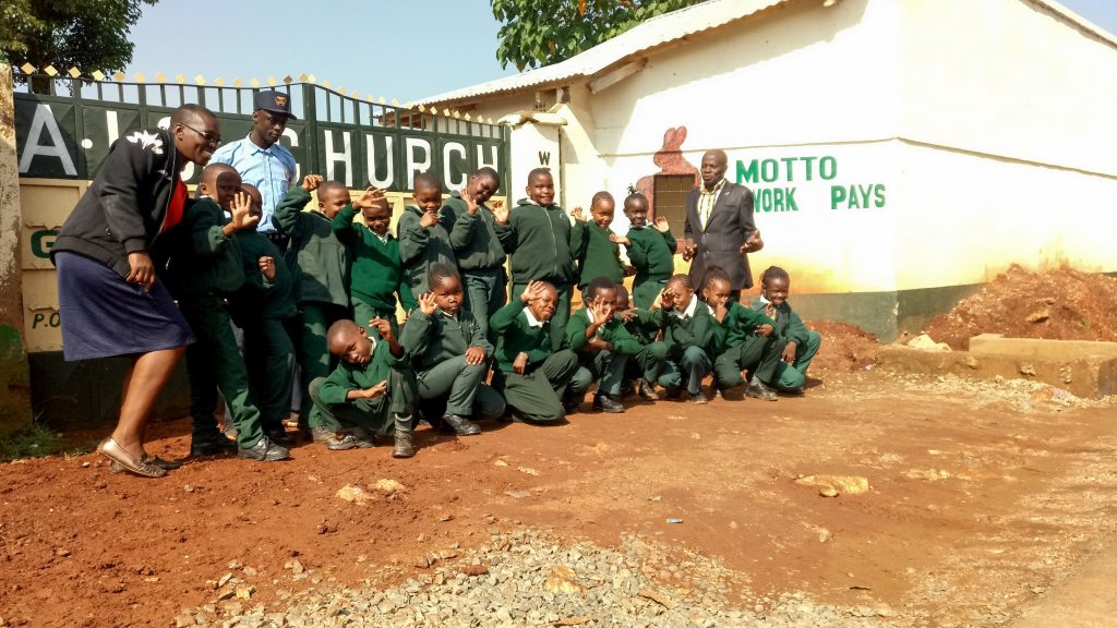 The Water Project : 2-kenya19003-our-team-members-posing-with-students-at-school-gate