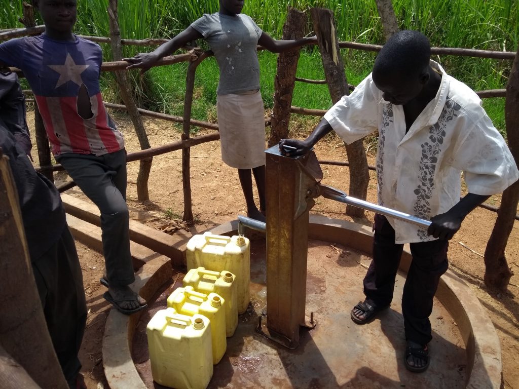The Water Project : uganda6080-community-members-using-the-water-point