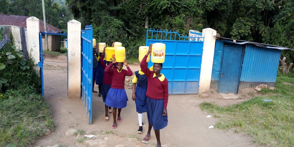 The Water Project : 9-kenya19022-arriving-at-school-with-water-again