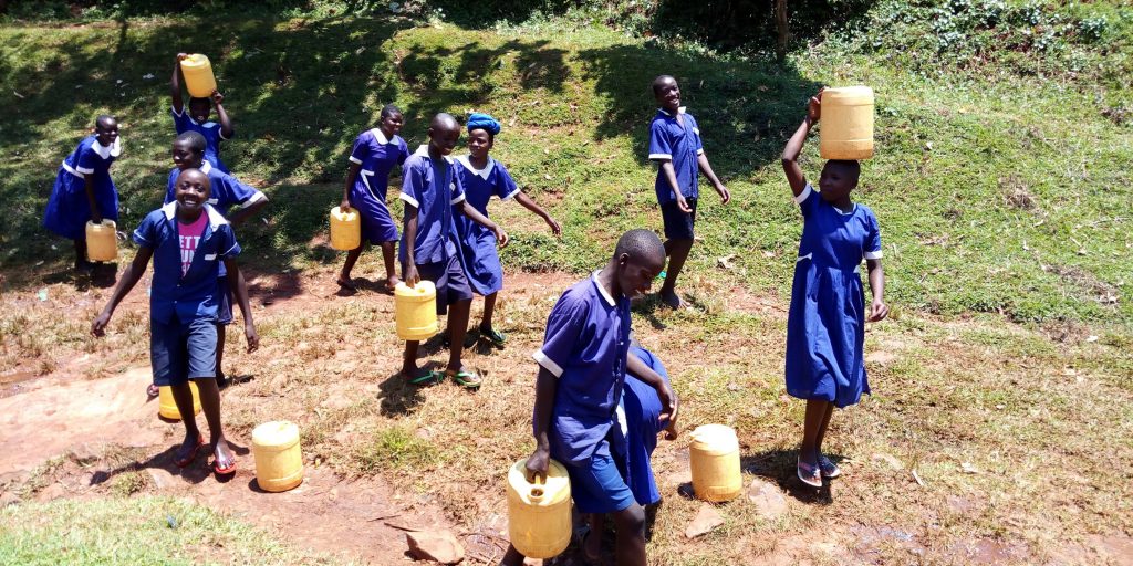The Water Project : 13-kenya19078-carrying-water-back-to-school