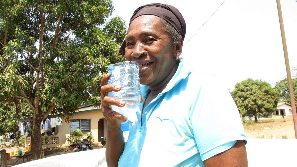 The Water Project : sierraleone19270-elderly-woman-drinking-from-well