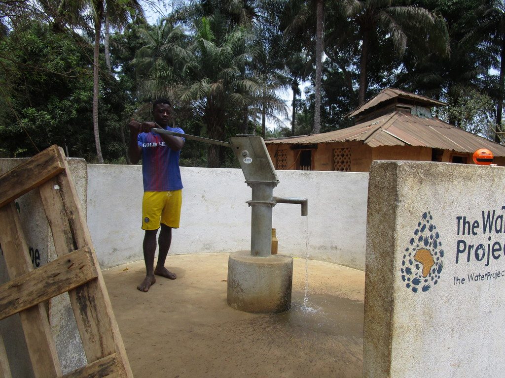 The Water Project : sierraleone18249-community-member-using-water-source