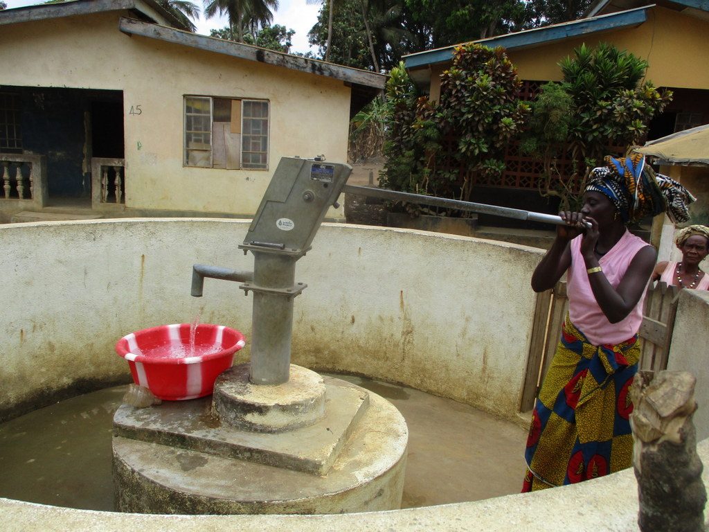 The Water Project : sierraleone18259-community-member-using-water-source