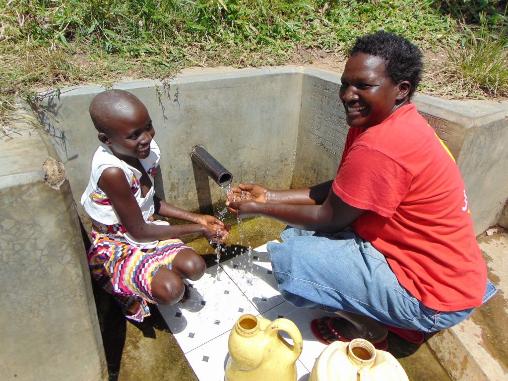 The Water Project : 3-kenya18153-celestine-and-violet-enjoying-the-spring-water