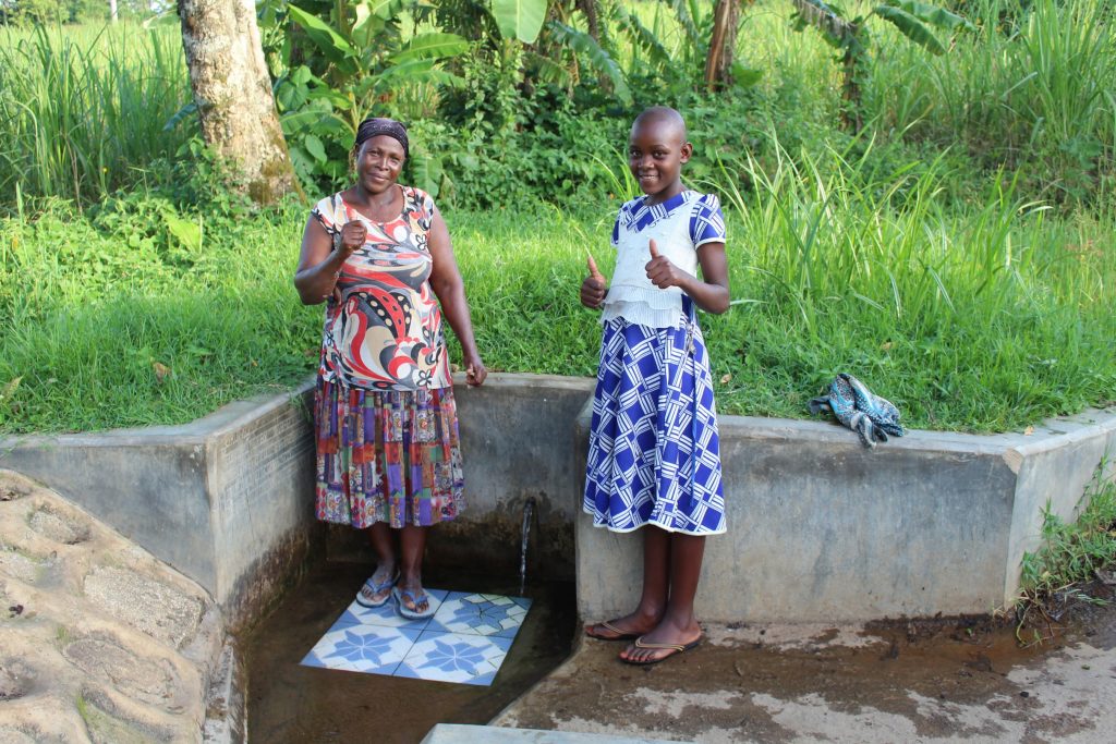 The Water Project : 4-kenya18129-felistus-and-lucy-give-thumbs-up-for-clean-water