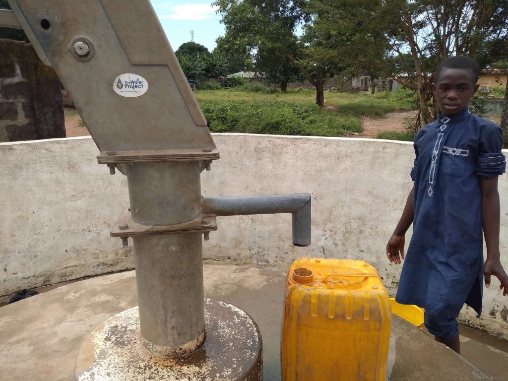 The Water Project : kenya18278-filling-up-at-well-a-year-later