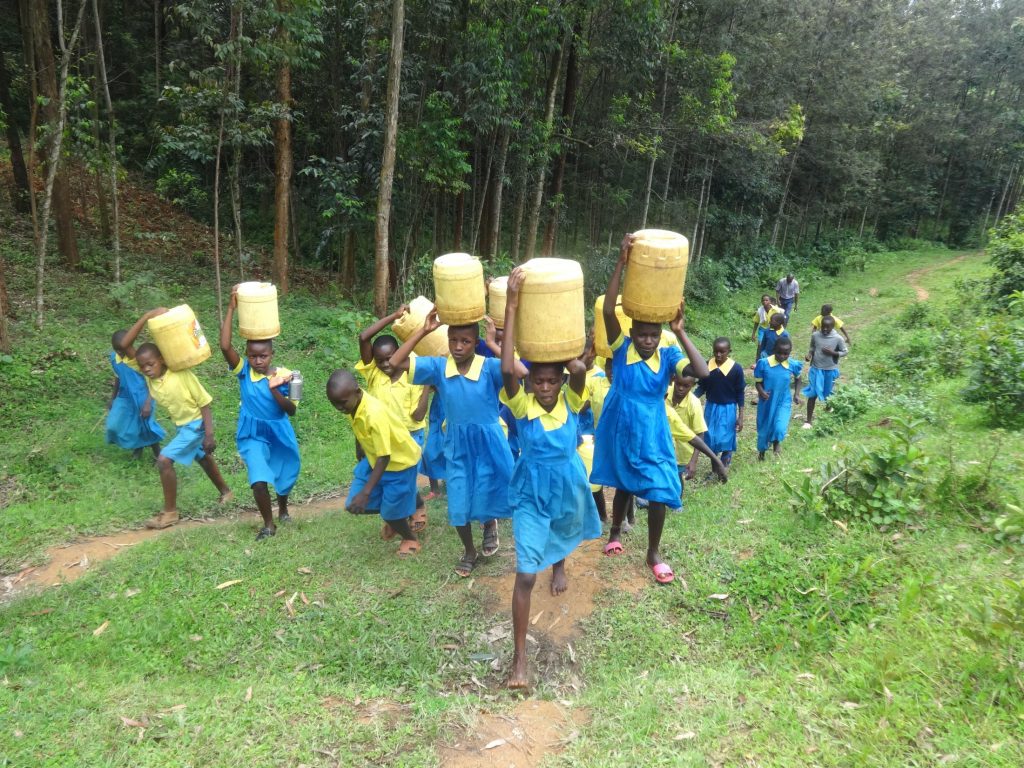 The Water Project : 23-kenya20146-pupils-carrying-water-back-to-school
