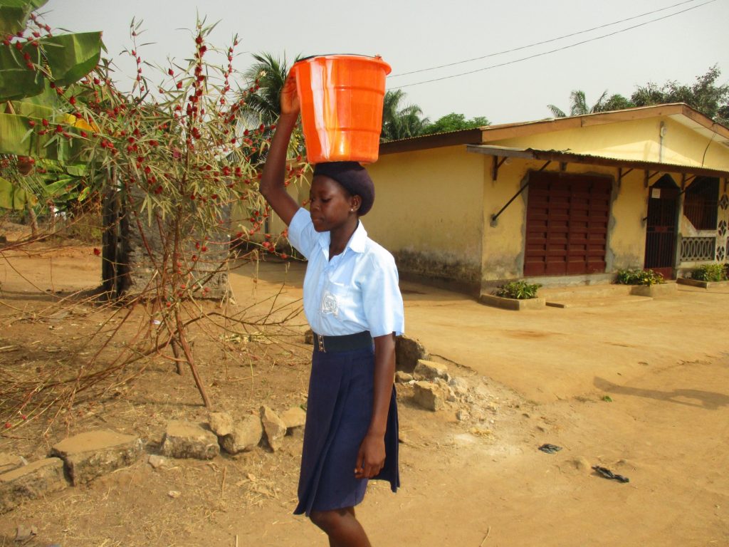 The Water Project : sierraleone20409-student-carrying-water-3