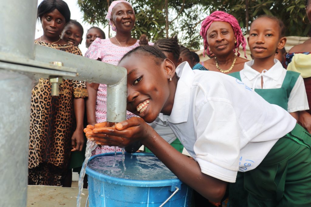 The Water Project : sierraleone20400-happy-student-drinks-from-well