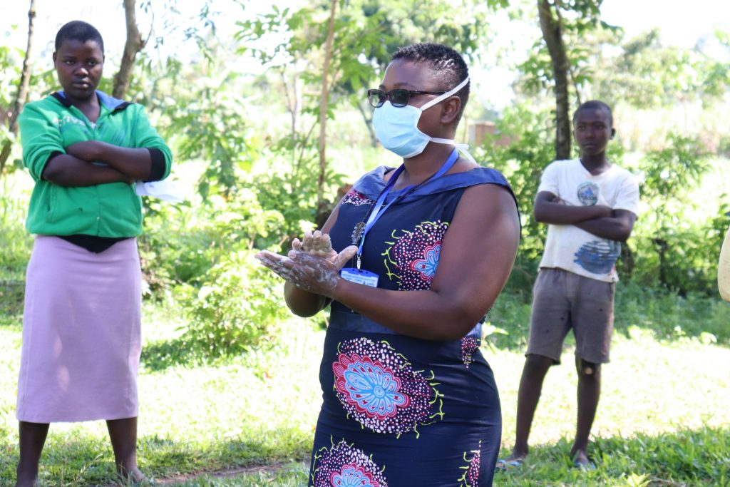 The Water Project : 4-covid19-kenya4434-trainer-chelagat-demonstrating-handwashing