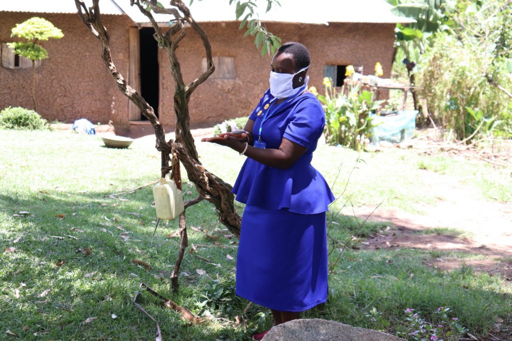 The Water Project : 6-kenya18153-covid-19-trainer-karen-maruti-demonstrates-handwashing