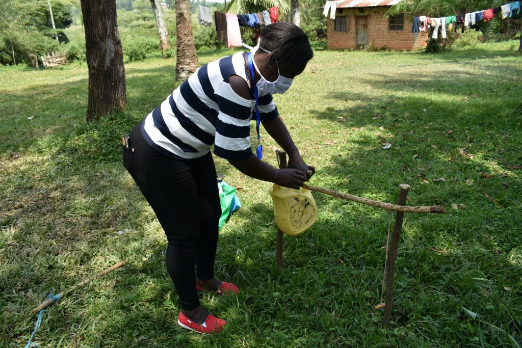 The Water Project : covid19-kenya4427-ms-laura-erecting-a-tippy-tap-handwashing-station