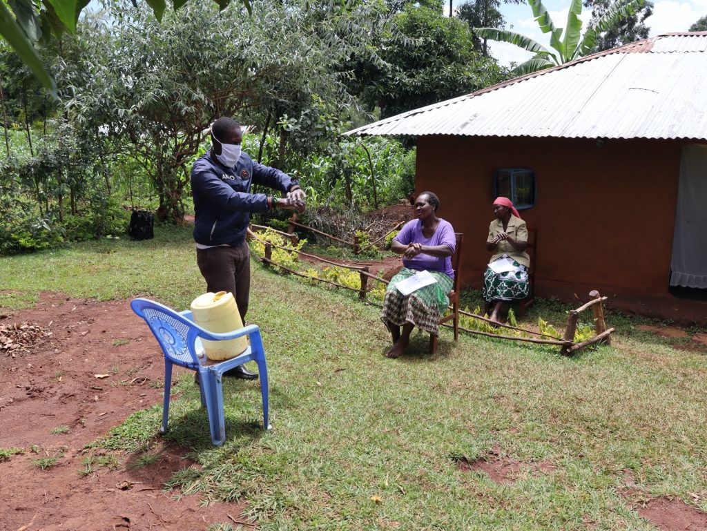 The Water Project : covid19-kenya4706-the-facilitator-demonstrating-the-ten-steps-of-handwashing