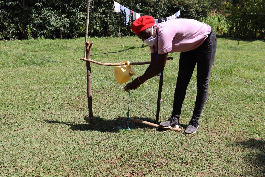 The Water Project : covid19-kenya18109-demonstration-on-using-the-installed-handwashing-station