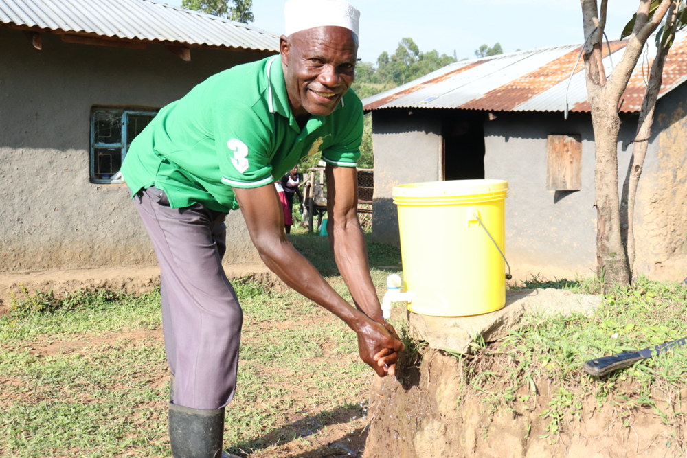 The Water Project : covid19-kenya20183-joshua-handwashing-at-home-1