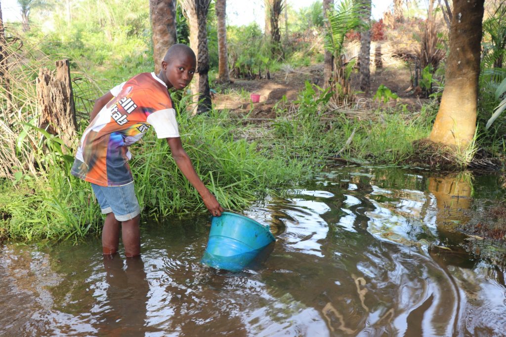 The Water Project : sierraleone20439-small-boy-collecting-water-2