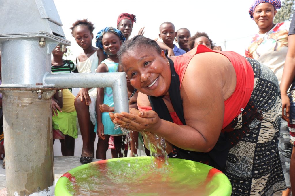 The Water Project : sierraleone20404-woman-joyfully-drinking-water