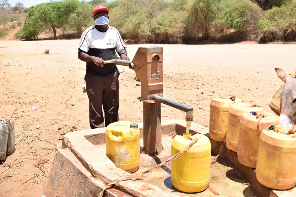 The Water Project : covid19-kenya4498-leonard-nguluma-maloloi-fetching-water-2