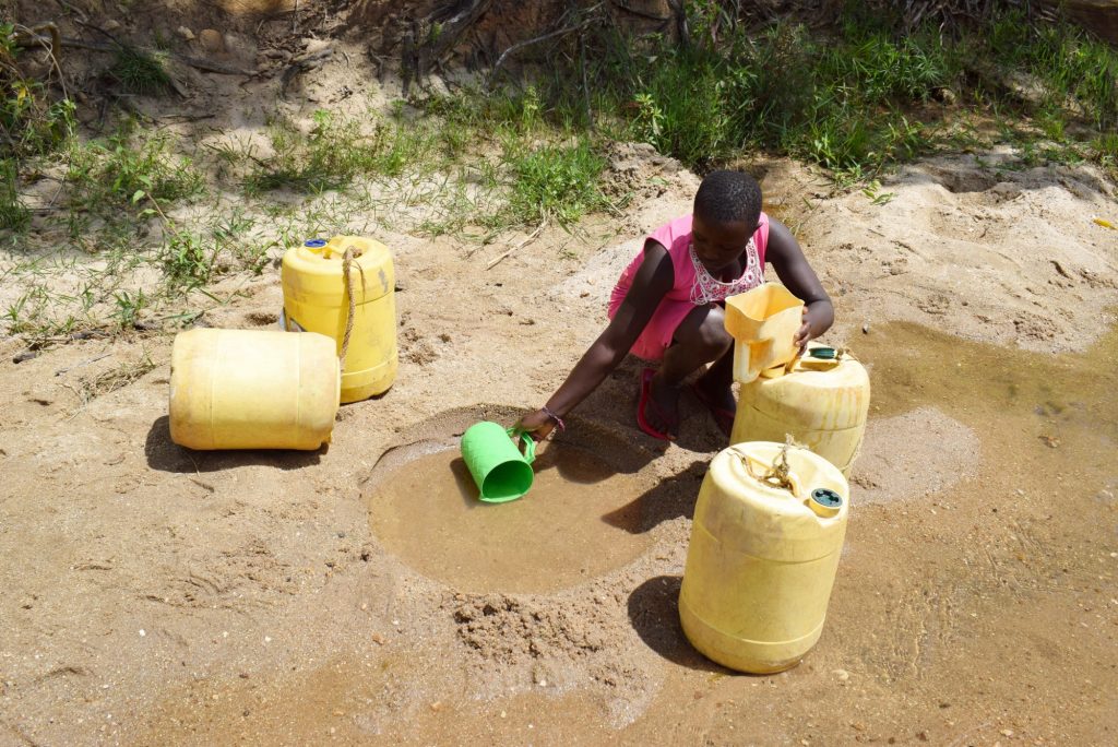 The Water Project : kenya21418-21419-collecting-water-at-the-scoop-hole