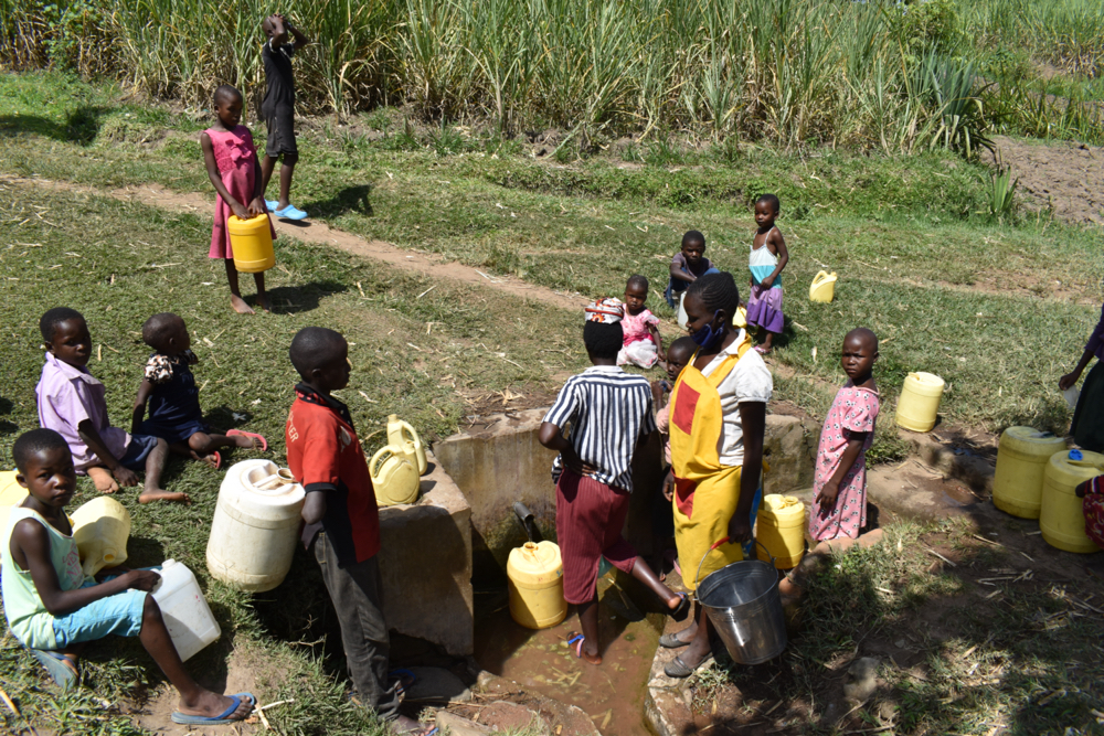 The Water Project : kenya21244-schools-staff-waiting-to-fetch-water-at-the-spring