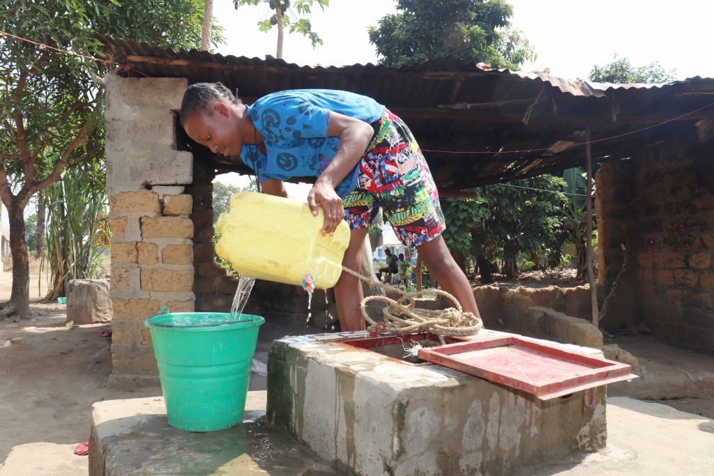 The Water Project : sierraleone21531-community-member-collecting-water-3