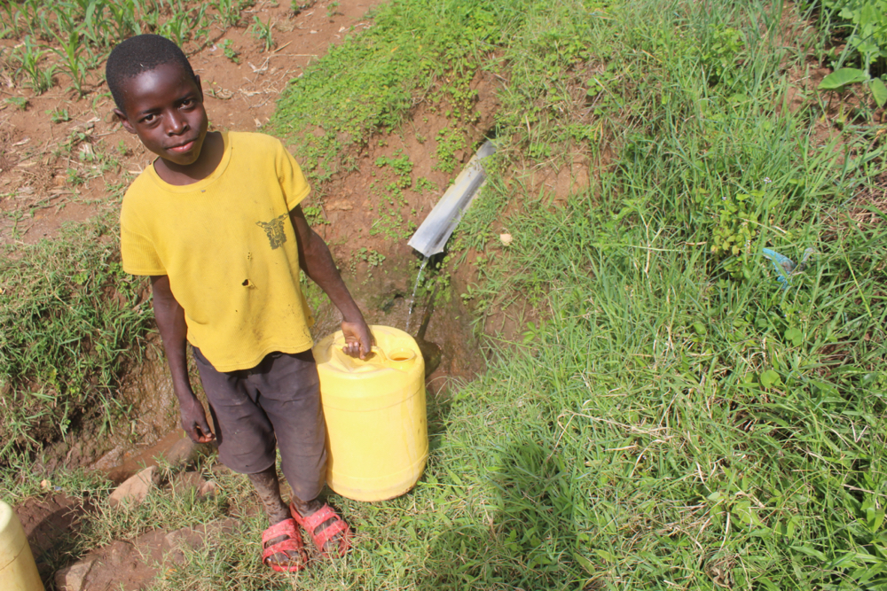 The Water Project : kenya21314-rodrick-fetching-water-1-2