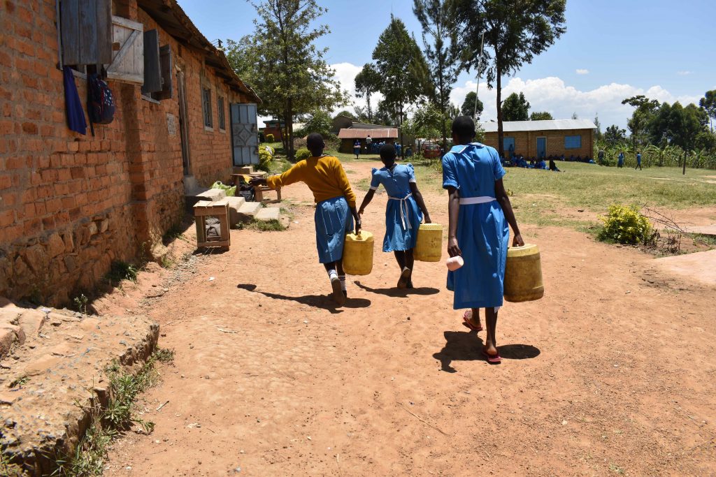 The Water Project : kenya22209-carrying-water-from-school-well-3
