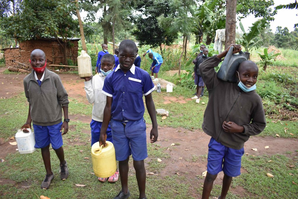 The Water Project : kenya22226-pupils-ferrying-water-1