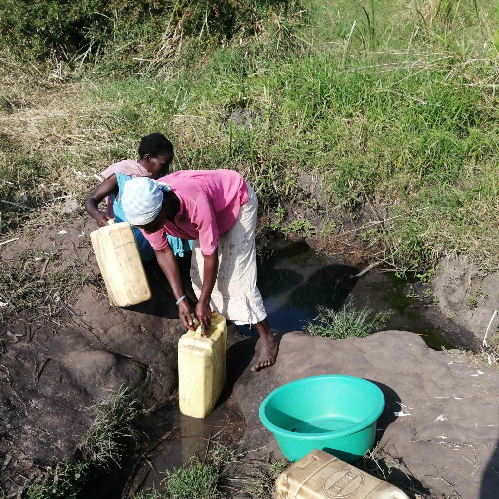 The Water Project : uganda22701-alima-fetching-water