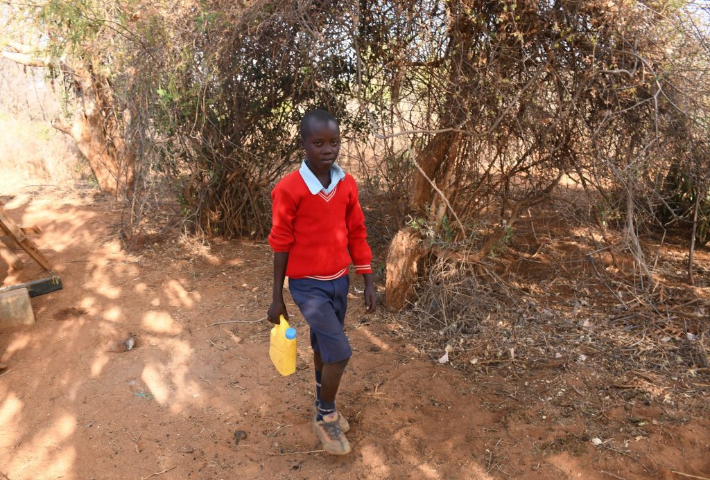 The Water Project : kenya22577-student-carrying-water-3