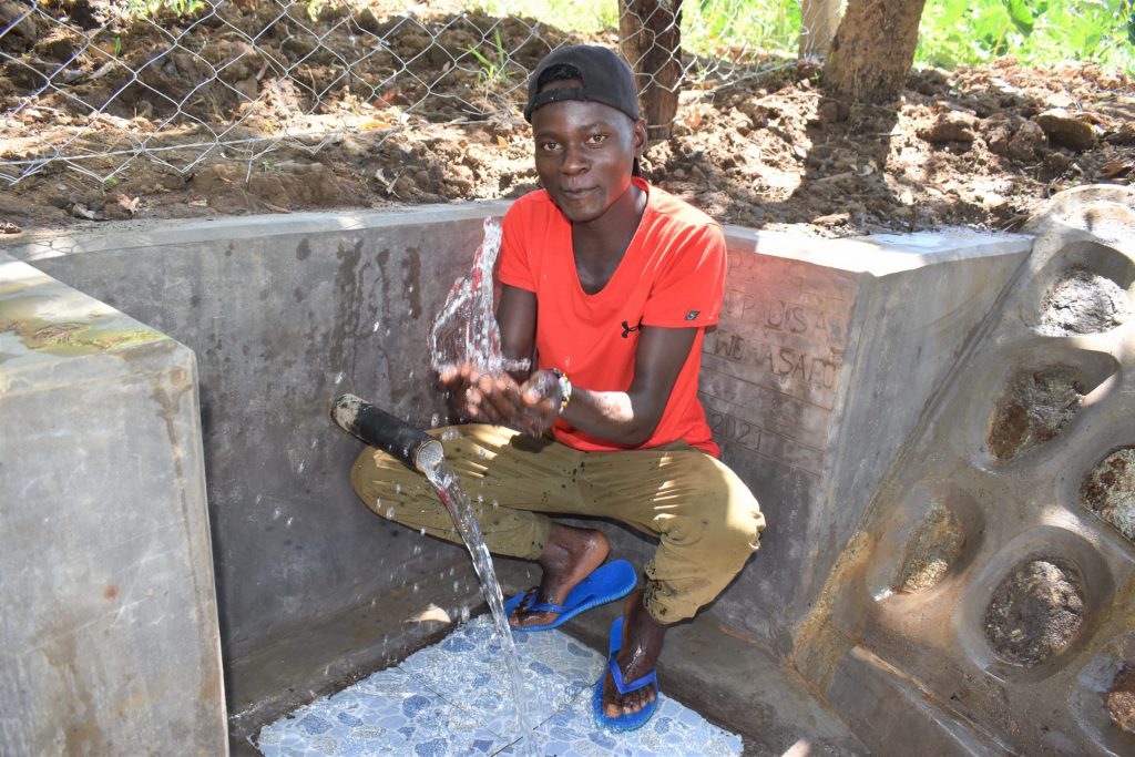 The Water Project : kenya21027-6-enjoying-flowing-water-2