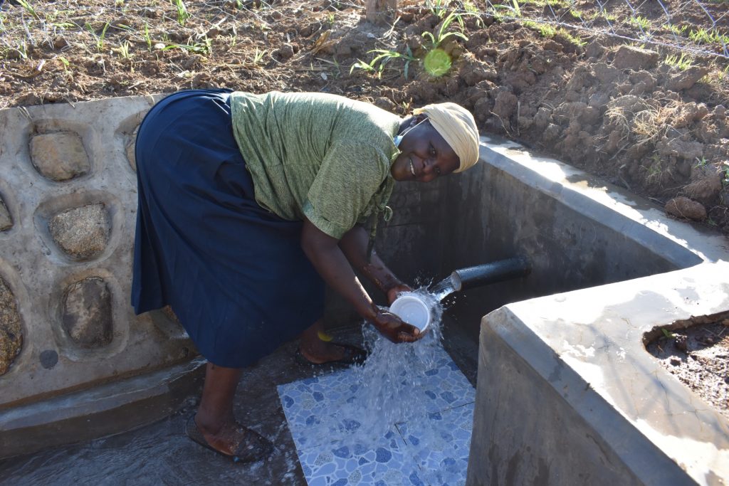 The Water Project : kenya21031-0-community-members-celebrating-water-3