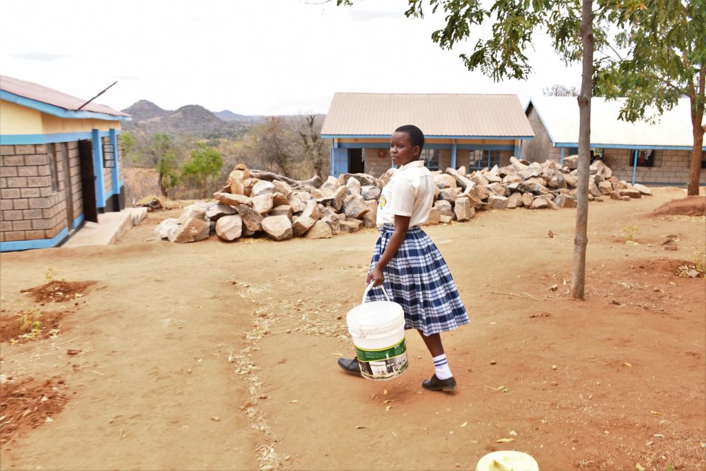 The Water Project : kenya22575-student-carrying-water-1
