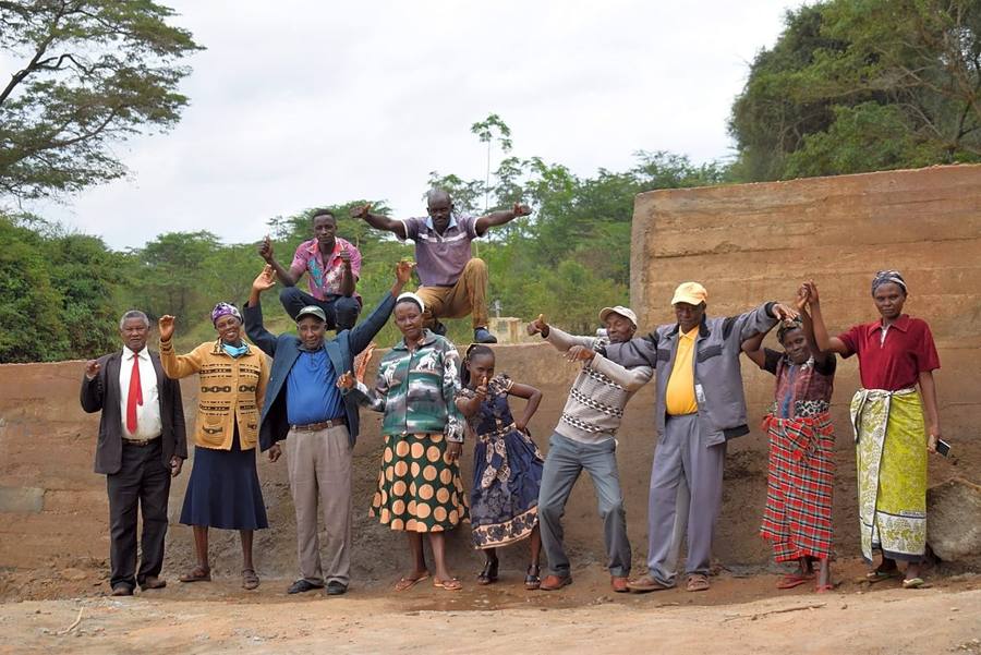 Community members celebrate on top of the finished sand dam in Kaketi, Kenya.